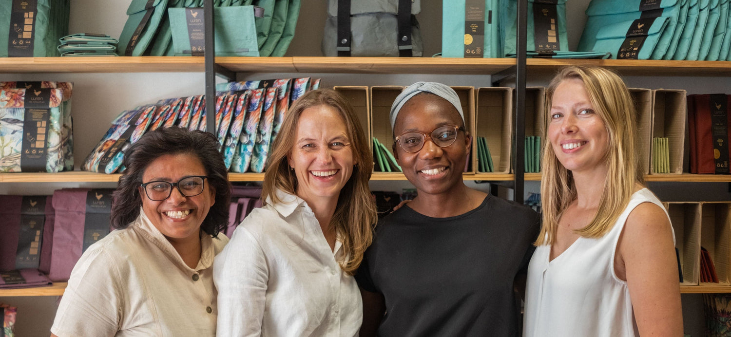 Four Wren women standing together in front of showroom shelves.